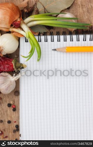 notebook for recipes and spices on an old wooden table