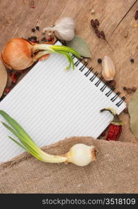 notebook for recipes and spices on an old wooden table