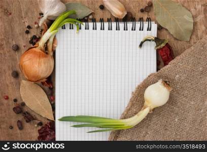 notebook for recipes and spices on an old wooden table