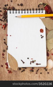 notebook for recipes and spices on an old wooden table