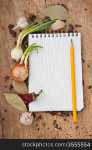 notebook for recipes and spices on an old wooden table