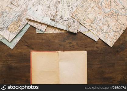 notebook near vintage maps