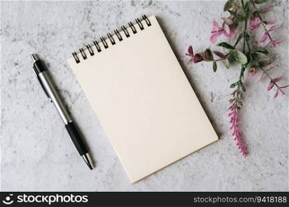 notebook, pen and flower is placed on white background