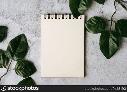 notebook, pen and leaf is placed on white background