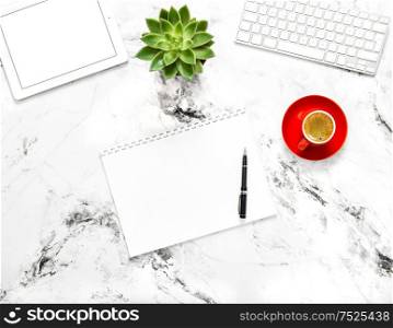 Notebook, tablet pc, coffee, succulent plant on marble background. Working desk. Flat lay