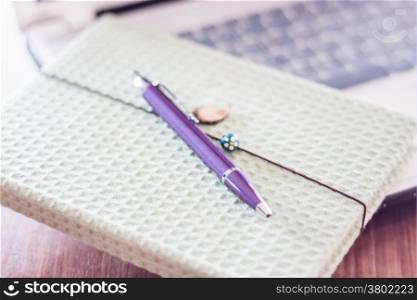 Notebook with computer on wooden table, stock photo