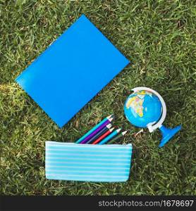 notebook with globe pencil case grass
