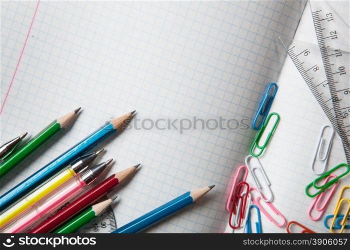 notebook with pencils and clips