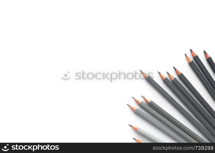 Notebook with pencils on a white background. Top view. Many gray pencils on a white background. Top view
