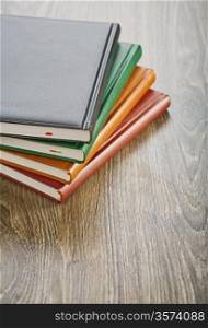 notebooks on wooden board
