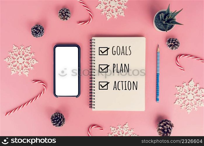 Notebooks with empty goals, plan, action and christmas decorations on color background
