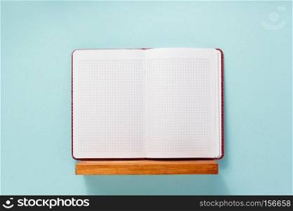 notepad and book on shelf at wall background surface