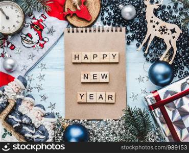 Notepad, Christmas decorations, Christmas tree branches and gift boxes. View from above, close-up, flat lay. Congratulations to loved ones, family, relatives, friends and colleagues. Merry Christmas and Happy New Year. Beautiful card