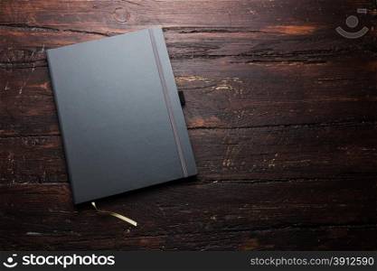 Notepad laying on a old dark wooden table