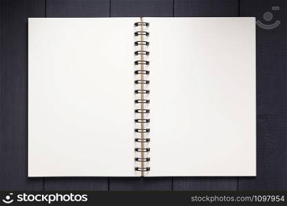 notepad or notebook paper at black wooden background surface table, top view