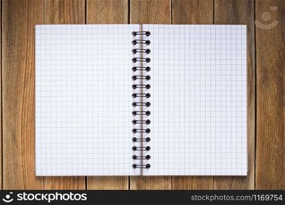 notepad or notebook paper at wooden background surface table, top view