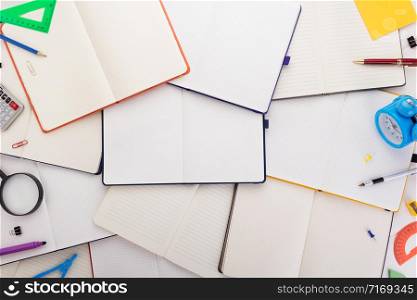 notepad or notebook with school supplies, top view
