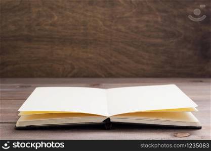 notepad or paper book at wooden table background surface table