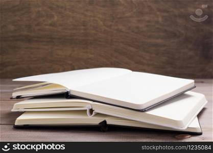 notepad or paper book at wooden table background surface table