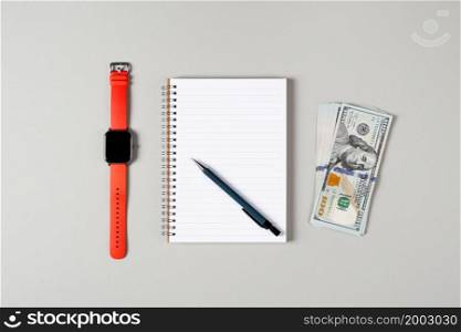 Notepad, pen, stack of money and a cup of black coffee isolated on gray background. Notepad with copy space. Office, business, financial growth concept.. Notepad, pen, stack of money and a cup of black coffee isolated on gray background. Notepad with copy space. Office, business, financial growth concept