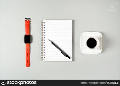 Notepad, watch, pen and a cup of coffee isolated on light gray background. Notepad with copy space. Office, business, discreet style.. Notepad, watch, pen and a cup of coffee isolated on light gray background. Notepad with copy space. Office, business, discreet style
