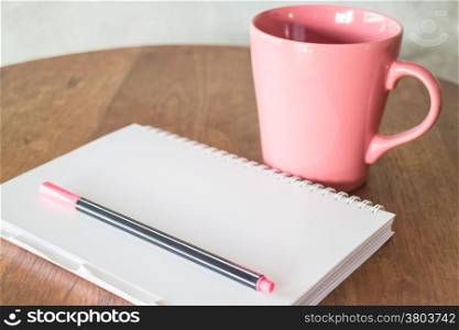 Notepaper and hot drink on wooden table, stock photo