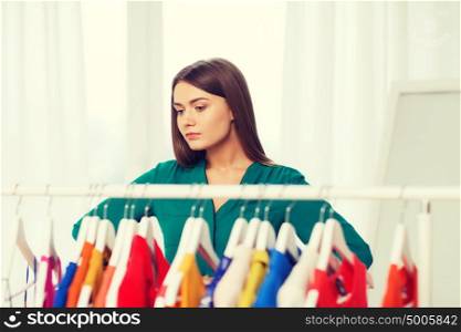 nothing to wear, clothing, fashion and style concept - woman choosing clothes at home wardrobe. woman choosing clothes at home wardrobe
