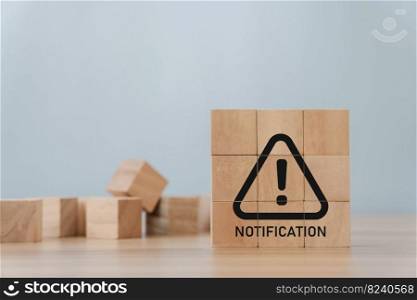 notification triangle warning sign icon on a wooden block. Ideas for Alarm Errors and Maintenance Ideas