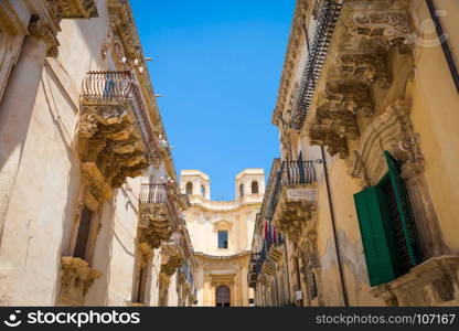 Noto town in Sicily, the Baroque Wonder - UNESCO Heritage Site. Detail of Palazzo Nicolaci balcony, the maximum expression of the Sicilian Baroque style.