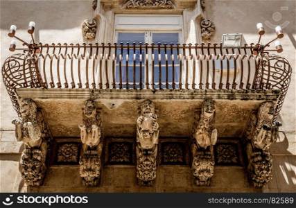 Noto town in Sicily, the Baroque Wonder - UNESCO Heritage Site. Detail of Palazzo Nicolaci balcony, the maximum expression of the Sicilian Baroque style.