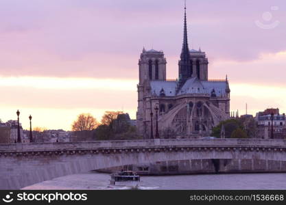 Notre Dame Cathedral on Ile de la Cite and Pont de la Tournelle over Seine river, Paris, France