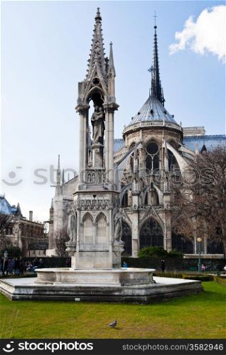 Notre-dame de paris and Fountain of the Virgin from Square Jean XXIII in Paris