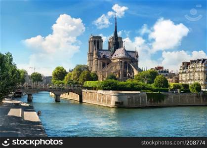 Notre Dame de Paris on river Seine and cloudy sky, France