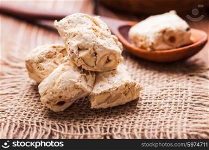 Nougat, typical italian dessert with nuts on a rustic table