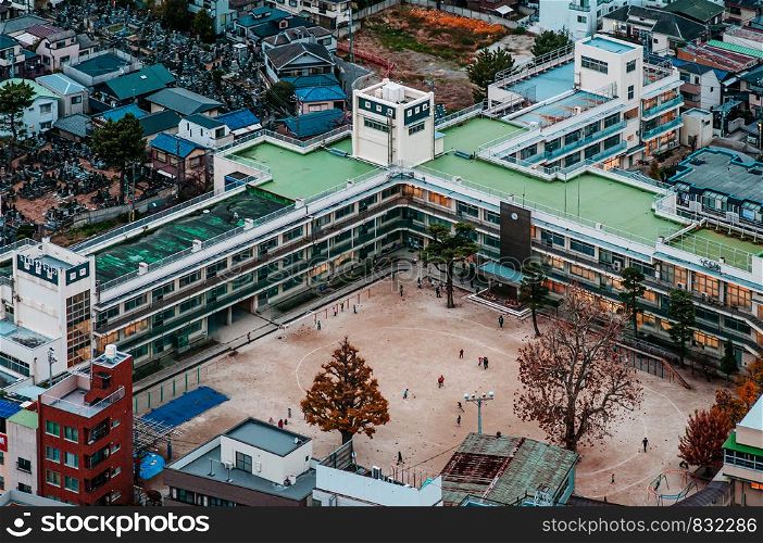NOV 29,2018 Tokyo, Japan - Aerial view of high school buildings in residential area of Ichikawa district with football field. Outer area of Tokyo