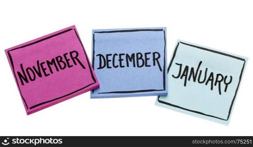 November, December and January - handwriting in black ink on isolated sticky notes