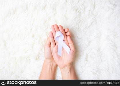 November Lung Cancer Awareness month, democracy and international peace day. Man holding white Ribbon on white background