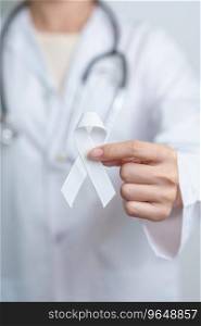November Lung Cancer Awareness month. Doctor with White ribbon in hospital. Healthcare and World Cancer day concept