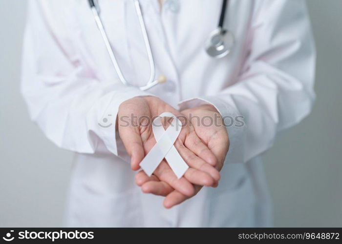 November Lung Cancer Awareness month. Doctor with White ribbon in hospital. Healthcare and World Cancer day concept