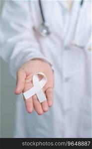 November Lung Cancer Awareness month. Doctor with White ribbon in hospital. Healthcare and World Cancer day concept