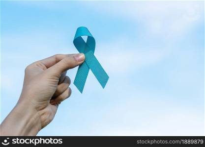 November Prostate Cancer Awareness month, man holding light Blue Ribbon for supporting people living and illness. Healthcare, International men, Father, World cancer day and world diabetes day concept