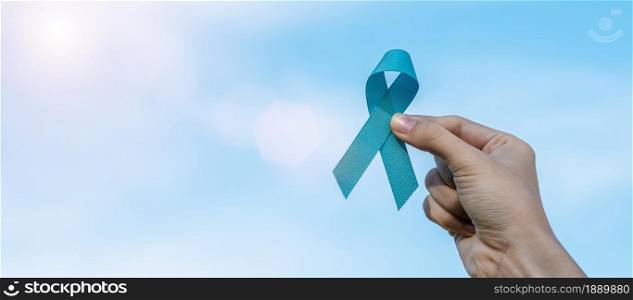 November Prostate Cancer Awareness month, man holding light Blue Ribbon for supporting people living and illness. Healthcare, International men, Father, World cancer day and world diabetes day concept