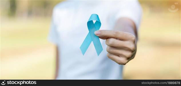November Prostate Cancer Awareness month, woman holding Blue Ribbon for supporting people living and illness. Healthcare, International men, Father, World cancer day and world diabetes day concept