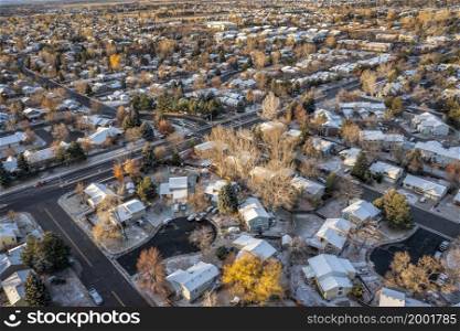 November sunrise over city of Fort Collins (residential area) in northern Colorado, aerial view in fall scenery with some snow