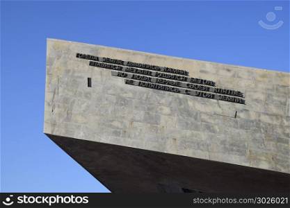 Novorossiysk, Naberezhnaya St. Admiral Serebryakova, memorial complex Malaya Zemlya. A triangular monument and a bas-relief of soldiers.. Novorossiysk, Russia - September 29, 2017: Novorossiysk, Naberezhnaya St. Admiral Serebryakova, memorial complex Malaya Zemlya. The inscription: The earth burned, the stones smoldered, the metal melted, concrete collapsed, but people loyal to their oath did not back away from this land.