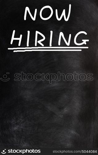 Now hiring - text written on a blank blackboard