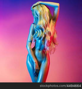 Nude beautiful blonde dancing in colorful light. Erotic portrait of sexy woman with long hairs.