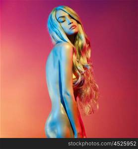 Nude beautiful blonde dancing in colorful light. Erotic portrait of sexy woman with long hairs.
