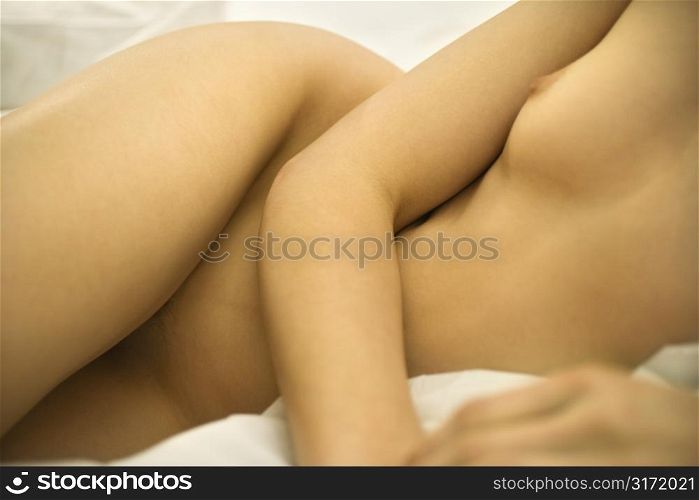 Nude Caucasian mid-adult female body reclining.