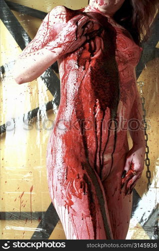 Nude female figure study dripping in blood, a very gothic image.